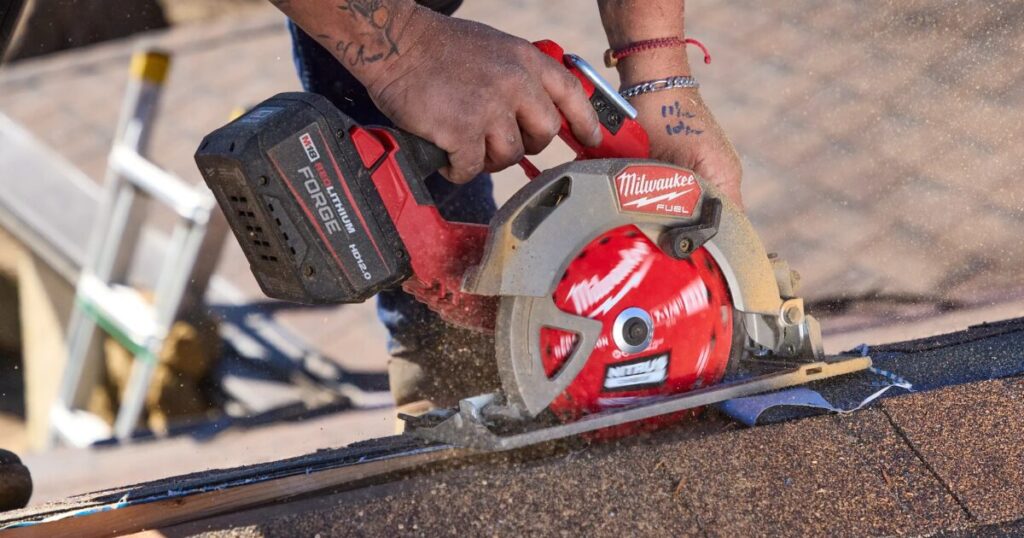 A Milwaukee M18 FUEL cordless circular saw fitted with an M18 FORGE HD12.0 battery, cutting roof decking on site