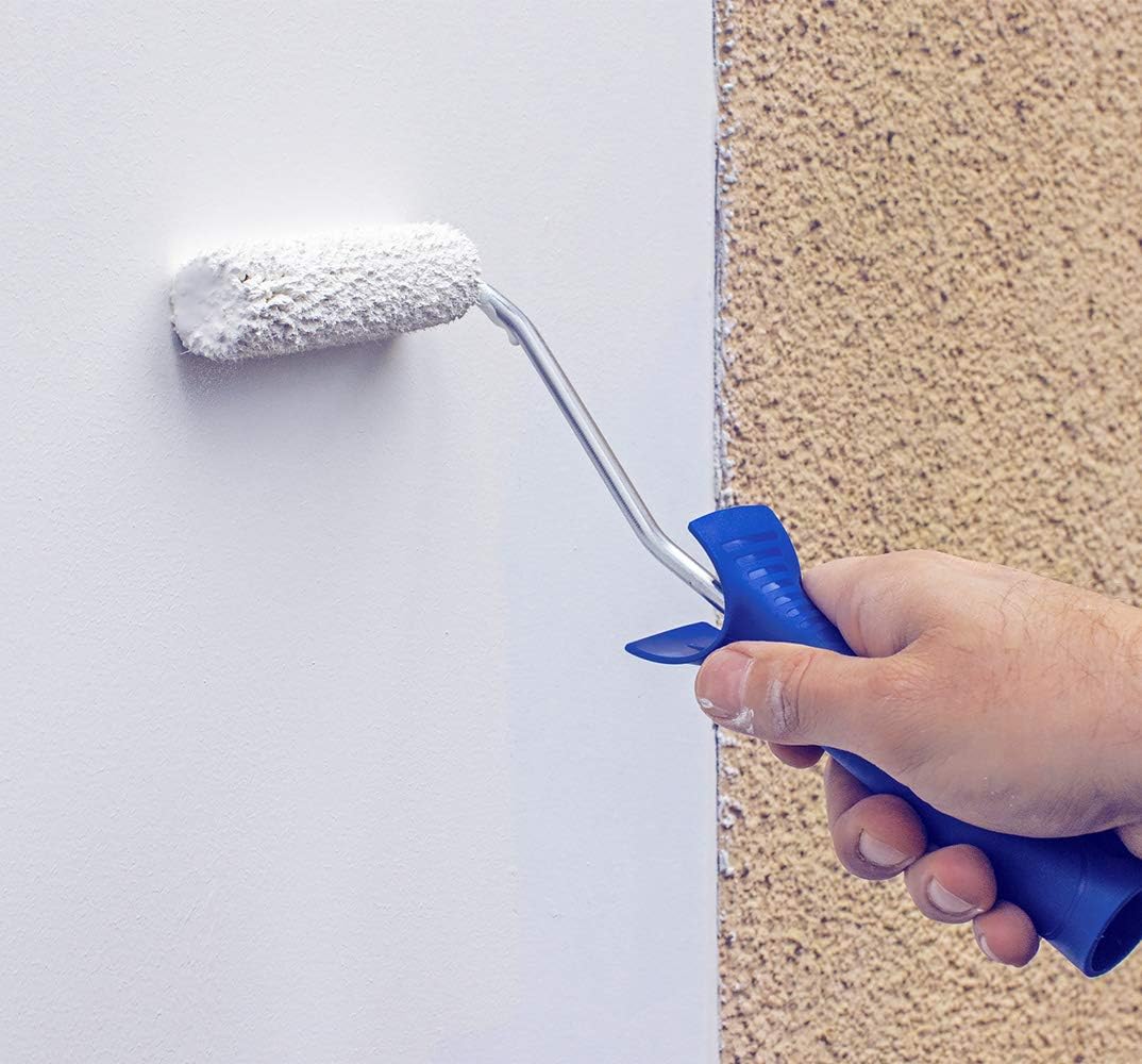 Close-up of a high-nap mini roller cover leaving a stippled texture as it is rolled across a wall beside a rough rendered surface