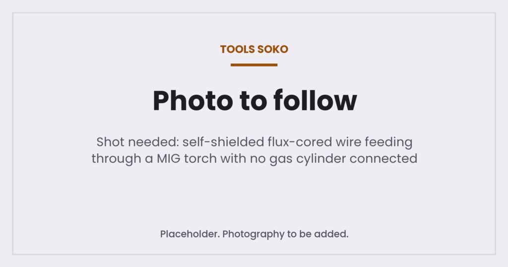 Placeholder image where a photograph of flux-cored wire feeding through a MIG torch without a gas cylinder will appear